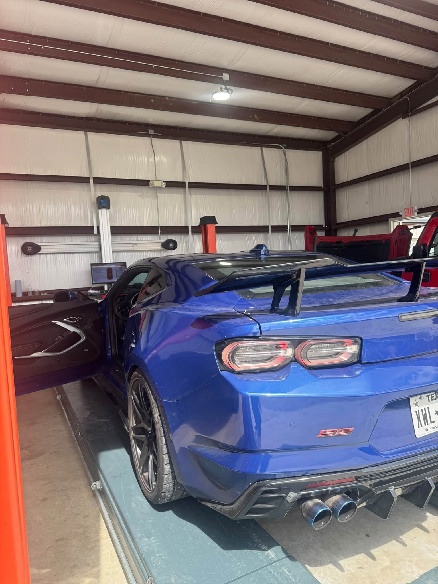Blue Chevrolet Camaro on a lift in the J&C shop